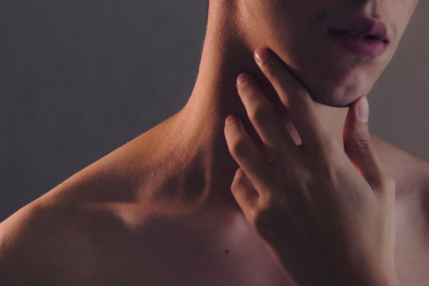 topless woman with left hand on her chin