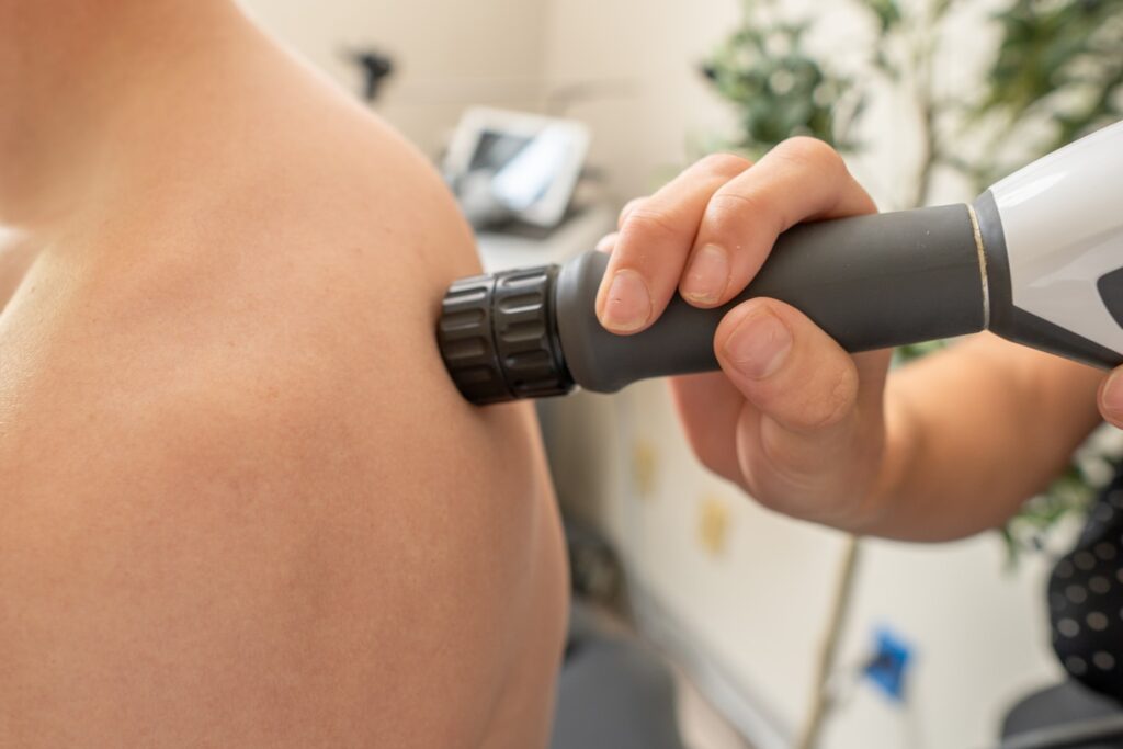 Patient receiving Shockwave Therapy in the shoulder area